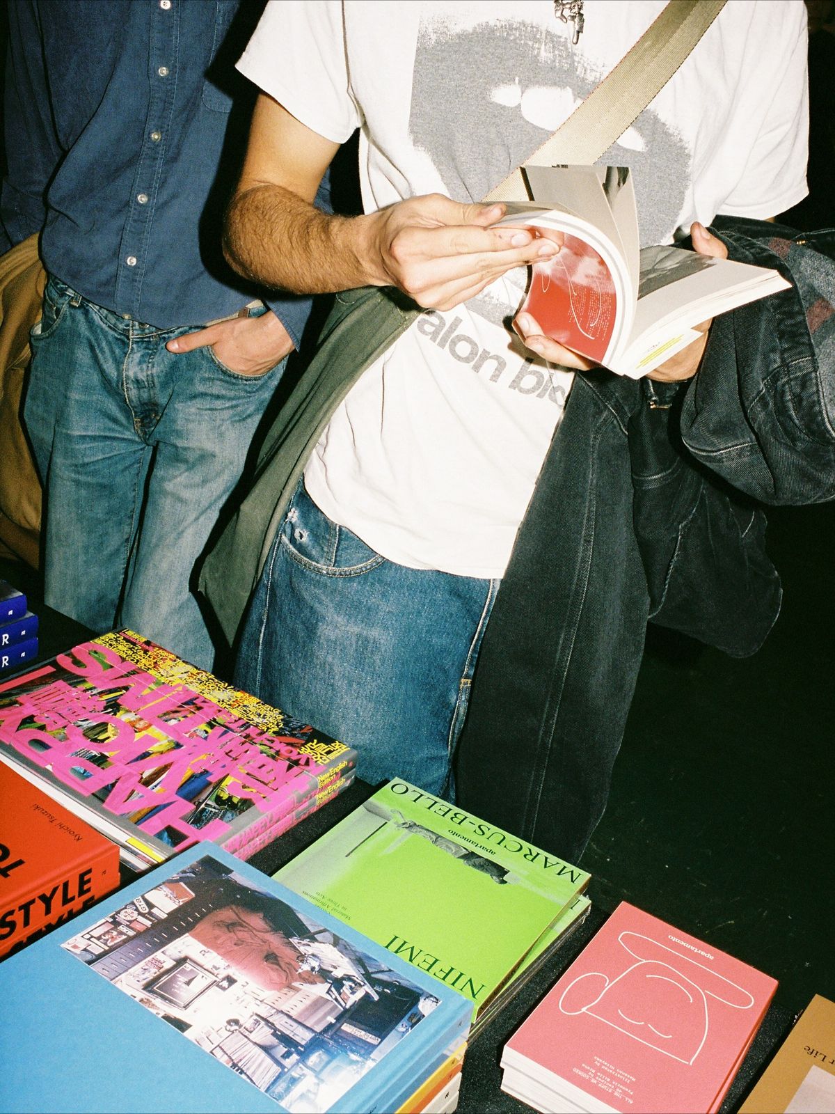 Festival visitors browsing colourful books at a table