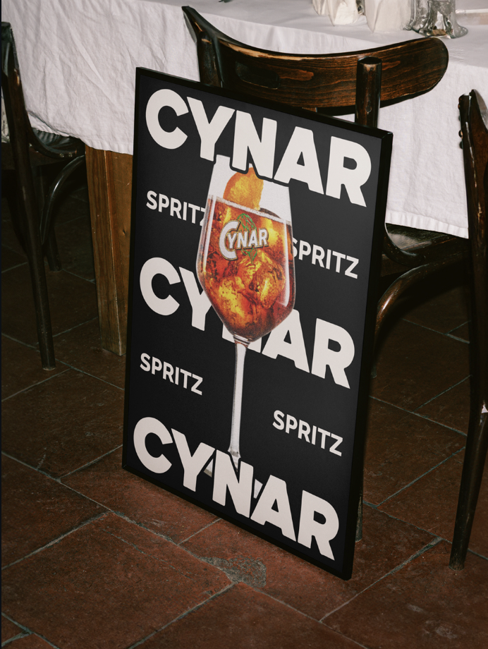 Cynar Spritz poster leaning against a chair